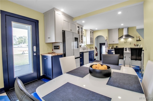 dining area featuring arched walkways and recessed lighting