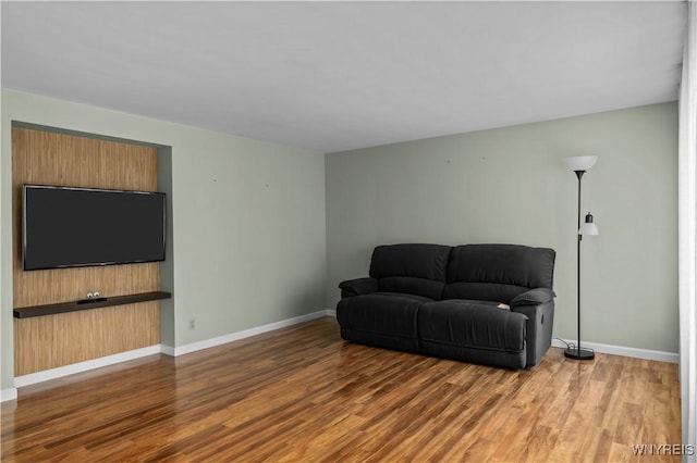 living area featuring wood finished floors and baseboards