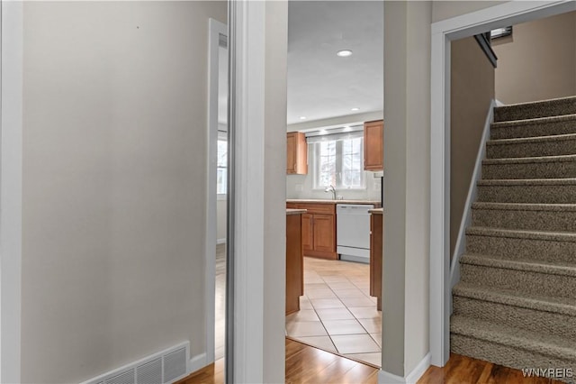 staircase with recessed lighting, visible vents, baseboards, and wood finished floors