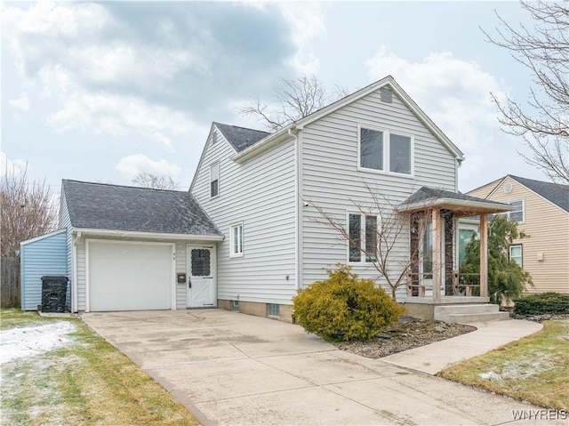 traditional-style home with a garage, concrete driveway, and a shingled roof