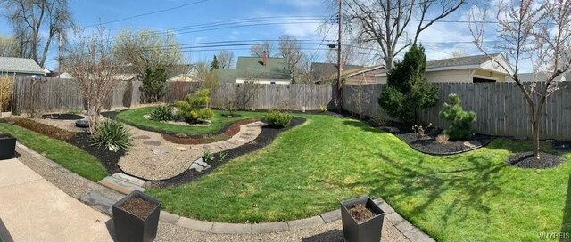 view of yard with a fenced backyard