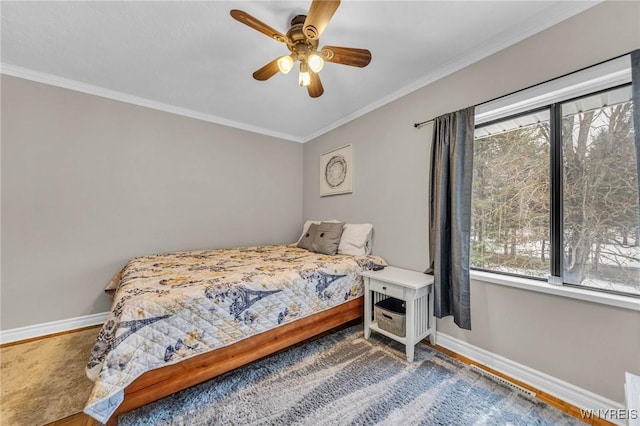 bedroom with ornamental molding, baseboards, and a ceiling fan