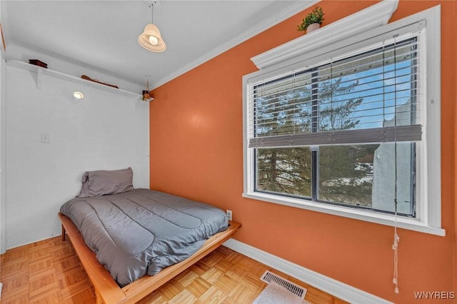 bedroom with ornamental molding, visible vents, and baseboards