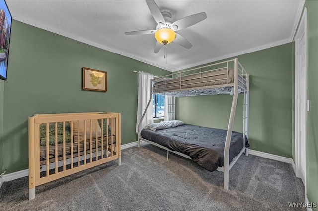 carpeted bedroom featuring baseboards, a ceiling fan, and crown molding