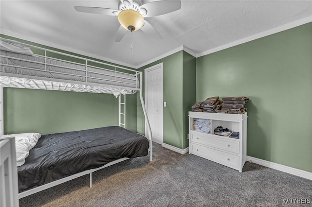 carpeted bedroom featuring baseboards, a ceiling fan, and crown molding