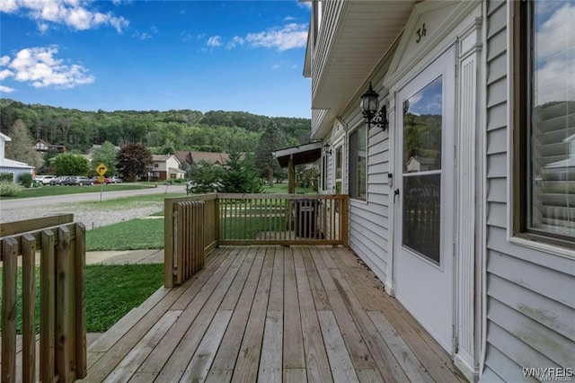 wooden deck featuring a view of trees