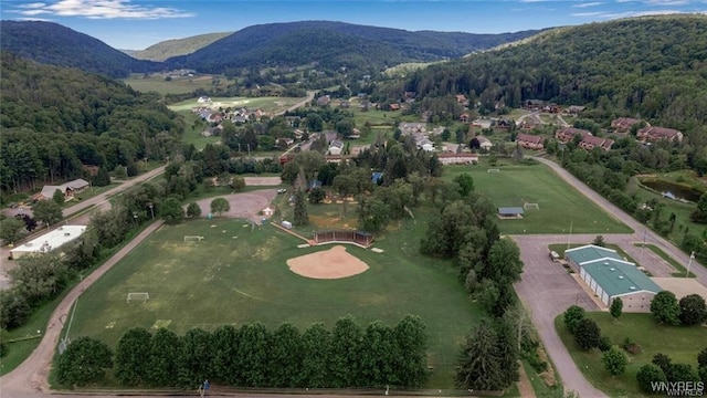 drone / aerial view with a mountain view and a wooded view