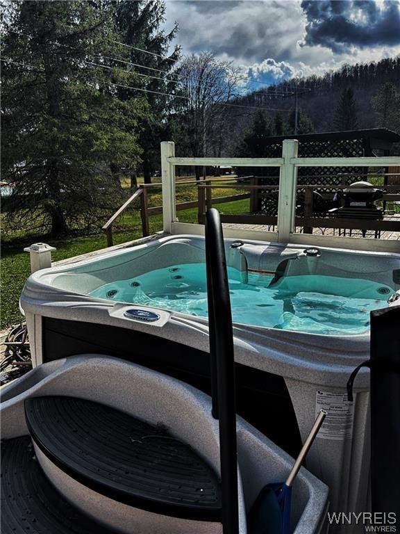 view of swimming pool featuring a hot tub