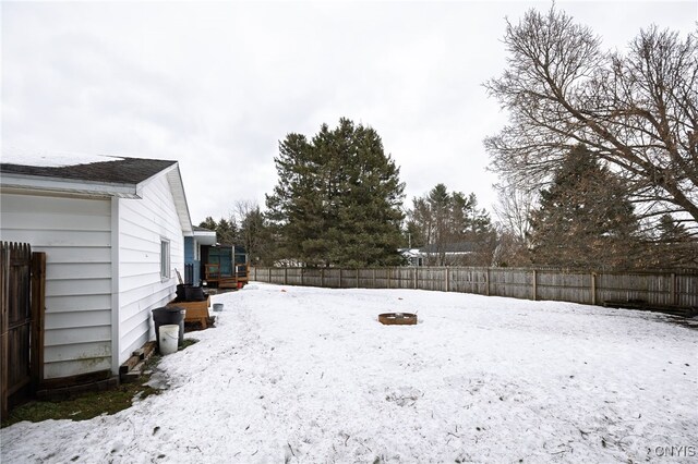 snowy yard with fence