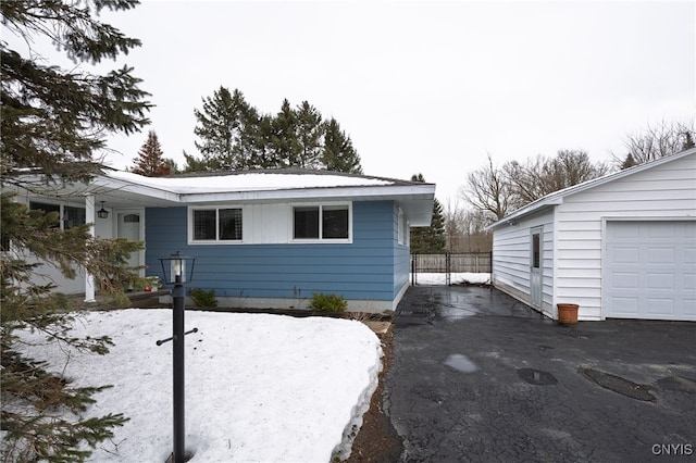 view of front of property with aphalt driveway and a garage