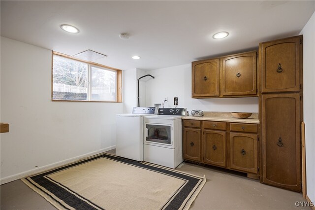 kitchen with finished concrete flooring, baseboards, brown cabinets, separate washer and dryer, and recessed lighting