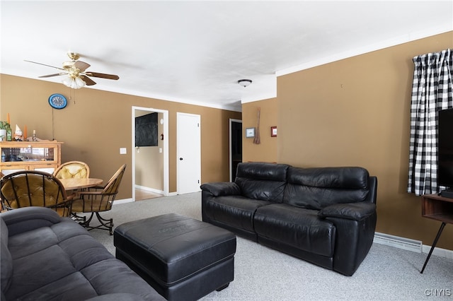 living area with a ceiling fan, carpet, and baseboards