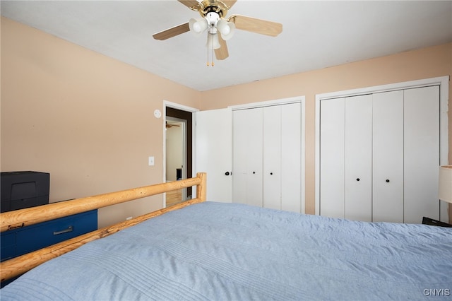 bedroom featuring multiple closets and a ceiling fan