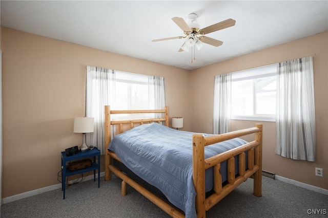 carpeted bedroom featuring multiple windows, baseboards, and a ceiling fan