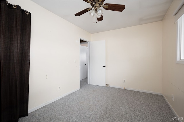 unfurnished bedroom featuring carpet, a ceiling fan, and baseboards