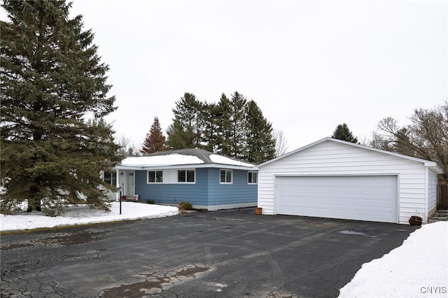 single story home featuring an outbuilding and a detached garage