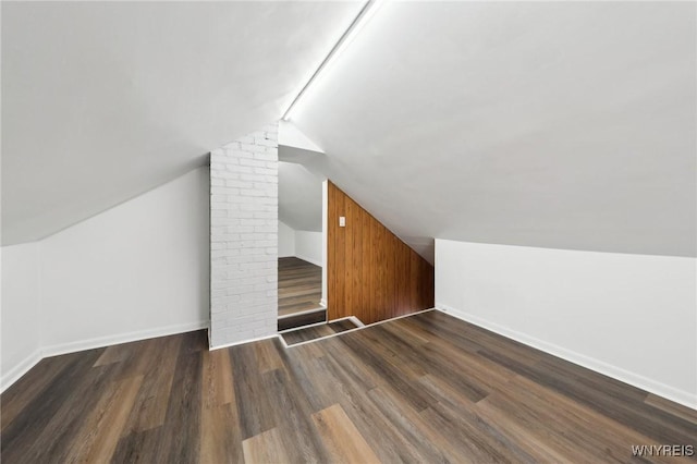 bonus room featuring vaulted ceiling, wood finished floors, and baseboards