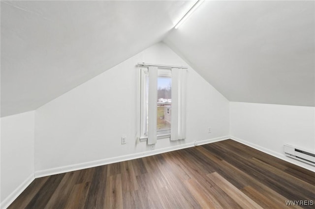 additional living space featuring lofted ceiling, baseboards, baseboard heating, and wood finished floors