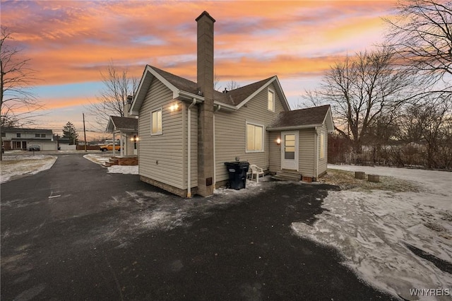 view of side of property featuring entry steps