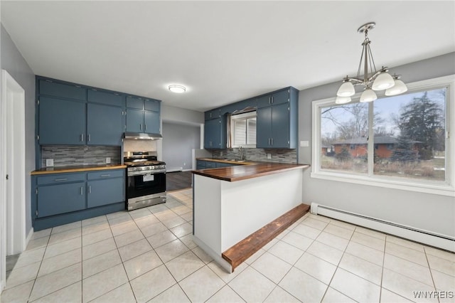 kitchen featuring blue cabinets, light tile patterned flooring, a sink, and gas range