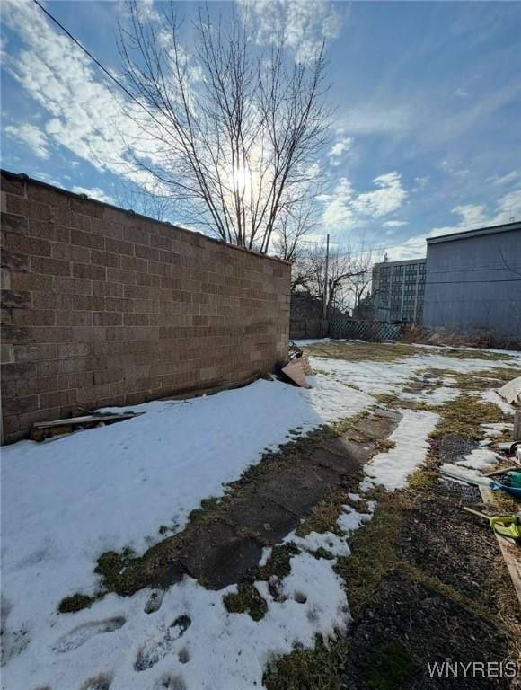 view of yard layered in snow