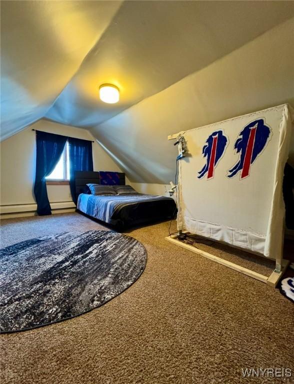 bedroom featuring lofted ceiling and carpet flooring