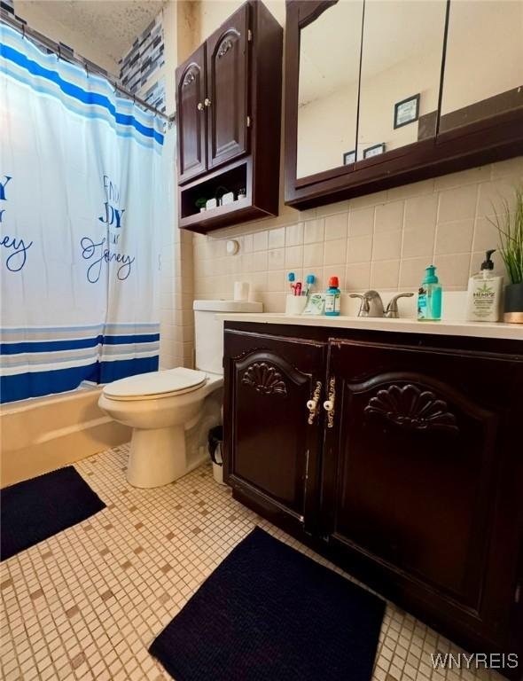 1258 W Ave, Buffalo, NY 14213 - full bath with vanity, toilet, backsplash, shower / tub combo, and tile patterned flooring