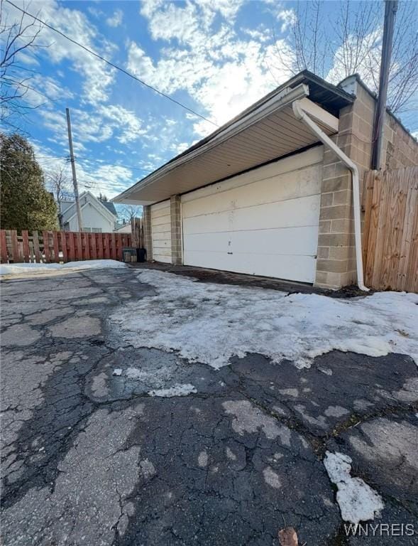 detached garage featuring fence