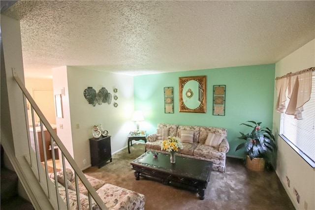 living area with a textured ceiling, stairs, baseboards, and carpet flooring