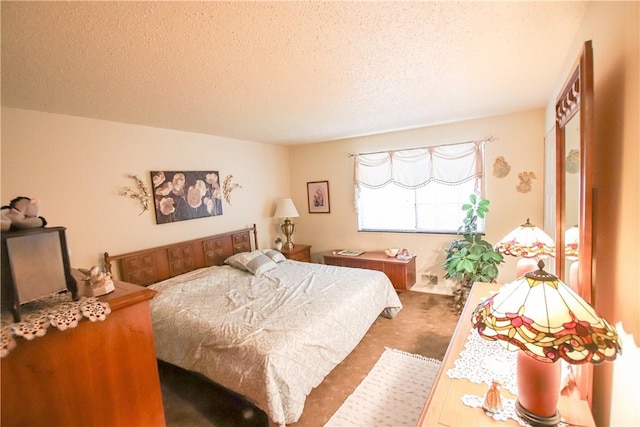 bedroom featuring a textured ceiling and carpet