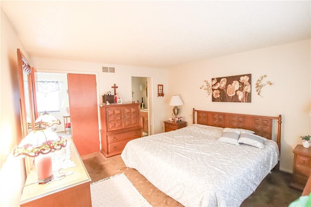 carpeted bedroom featuring visible vents