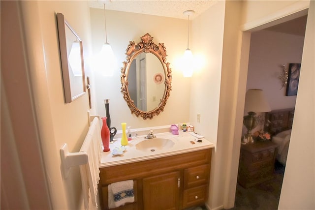 bathroom featuring a textured ceiling and vanity