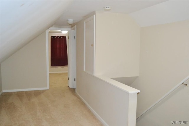 bonus room featuring vaulted ceiling, light carpet, and baseboards