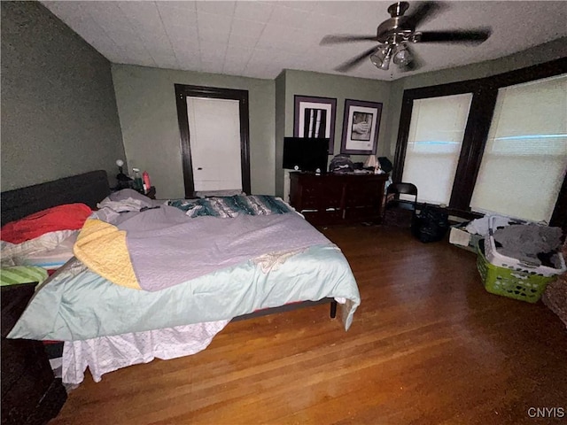 bedroom featuring ceiling fan and wood finished floors