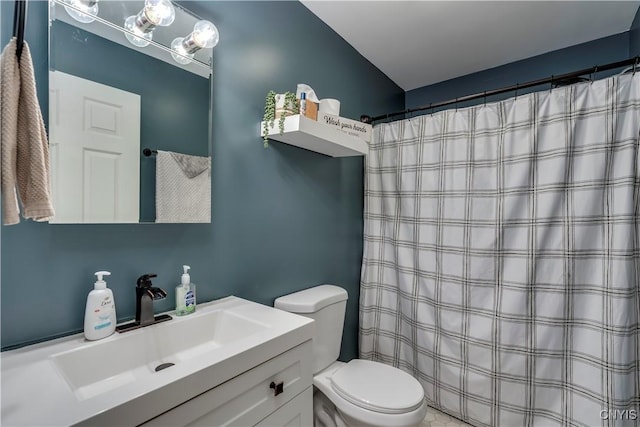 bathroom featuring curtained shower, vanity, and toilet