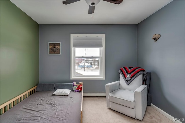 bedroom with ceiling fan, baseboard heating, carpet, and baseboards