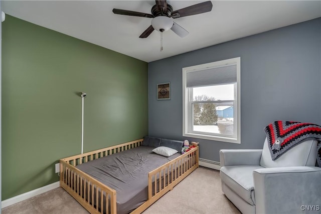 carpeted bedroom with a baseboard radiator, baseboards, and ceiling fan