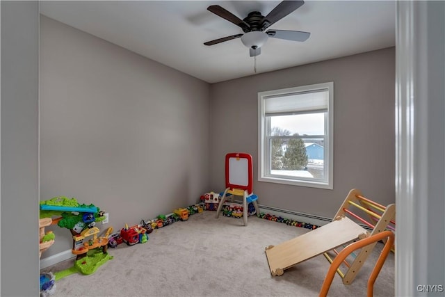 playroom featuring ceiling fan, carpet floors, and a baseboard radiator