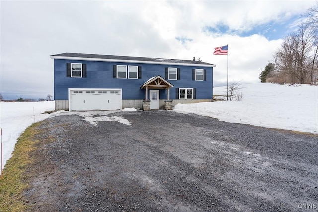 view of front of house featuring a garage and dirt driveway