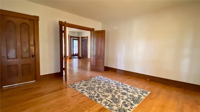 unfurnished room featuring wood finished floors and baseboards