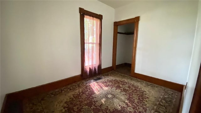 spare room featuring baseboards