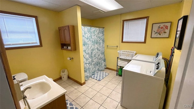 bathroom with baseboards, washing machine and dryer, a shower with shower curtain, tile patterned floors, and vanity