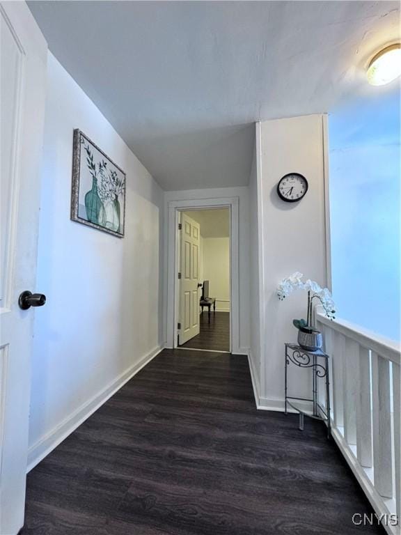 hall featuring dark wood finished floors and baseboards