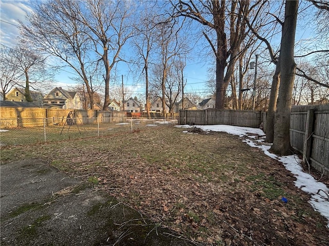 view of yard featuring a fenced backyard and a residential view