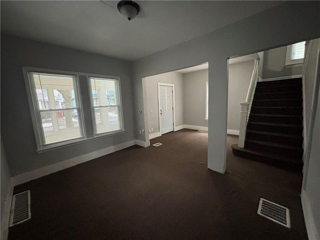 interior space featuring a healthy amount of sunlight, stairway, and visible vents