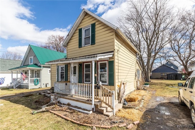 view of front of house with covered porch and a front lawn