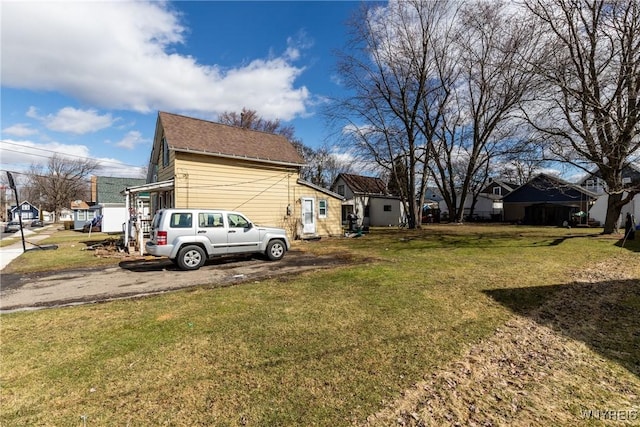 view of home's exterior with a yard