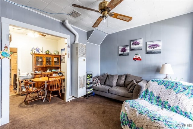 living area with carpet floors, visible vents, and a ceiling fan