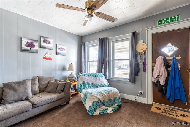 carpeted living room featuring ceiling fan and baseboards