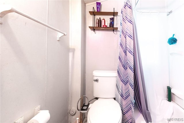 bathroom with curtained shower and toilet